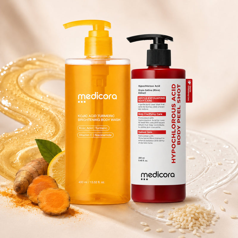 Both Medicora bottles beside turmeric root, lemon and rice grains